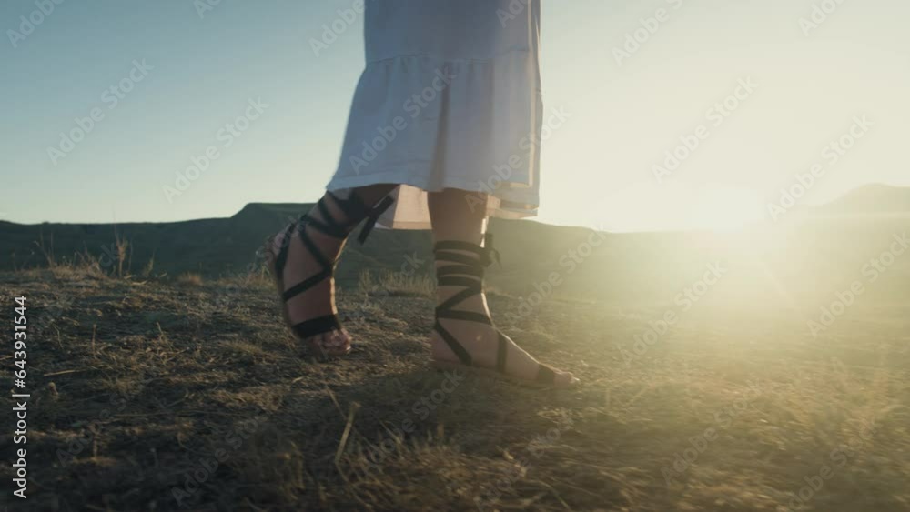 women's legs feet close-up walk along beach river banks, stepping ...