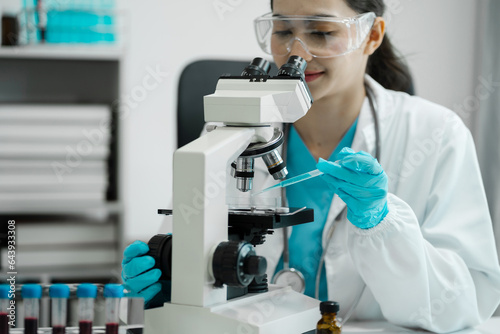 Female scientist researcher conducting an experiment working in the chemical laboratory.