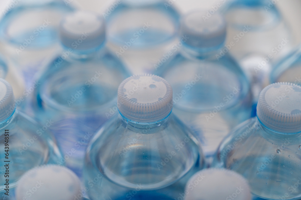 Transparent plastic bottles, containing water, next to each other. Use and recycling of plastic.
Transparent plastic bottles, containing water, next to each other. Use and recycling of plastic.