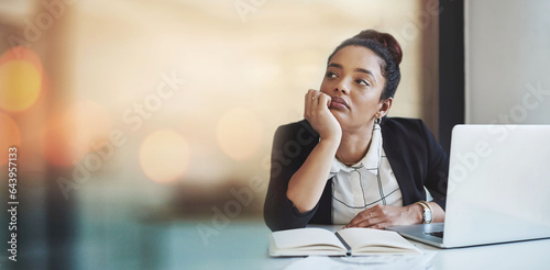 Laptop, notebook and a bored business woman in her office thinking or problem solving on banner space. Computer, research and idea with a young employee looking for inspiration in the workplace