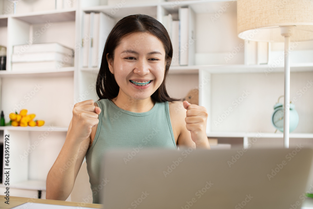 Joyful, Surprised or shocked Asian woman raised her arms all the way because she did a good job the boss gave her a big bonus making her very happy, Raise your hand, Smiling and screaming for success. Joyful, Surprised or shocked Asian woman raised her arms all the way because she did a good job the boss gave her a big bonus making her very happy, Raise your hand, Smiling and screaming for success.