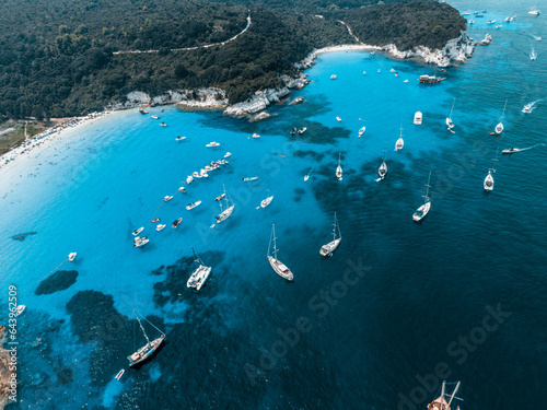 drone photo of beautiful exotic paradise turquoise sandy beach of Voutoumi with sail boats anchored in island of Anti paxos, Ionian sea, Greece