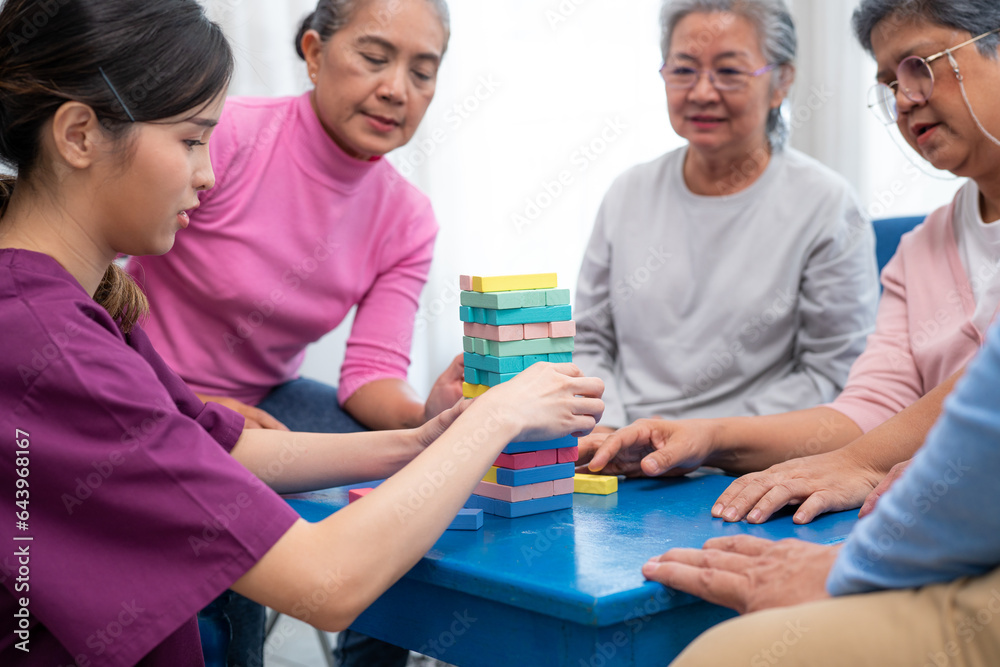 Group of senior people sitting at the table and playing board games together in nursing home Group of senior people sitting at the table and playing board games together in nursing home