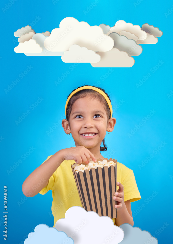 Paper, cloud and girl child with popcorn in studio for cinema, fantasy or creative space on blue background. Kindergarten, lesson and kid with snack for movie, learning or creativity and television Paper, cloud and girl child with popcorn in studio for cinema, fantasy or creative space on blue background. Kindergarten, lesson and kid with snack for movie, learning or creativity and television