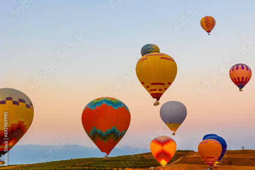 Hot air balloons at sunset , Turkey. Hot Air balloons flying tour over Mountains landscape sunrise , Turkey nature background.
