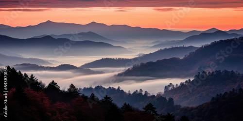The mountains are shrouded in mist. A twilight shot of autumn mountains under a fading red orange purple sky. © red_orange_stock
