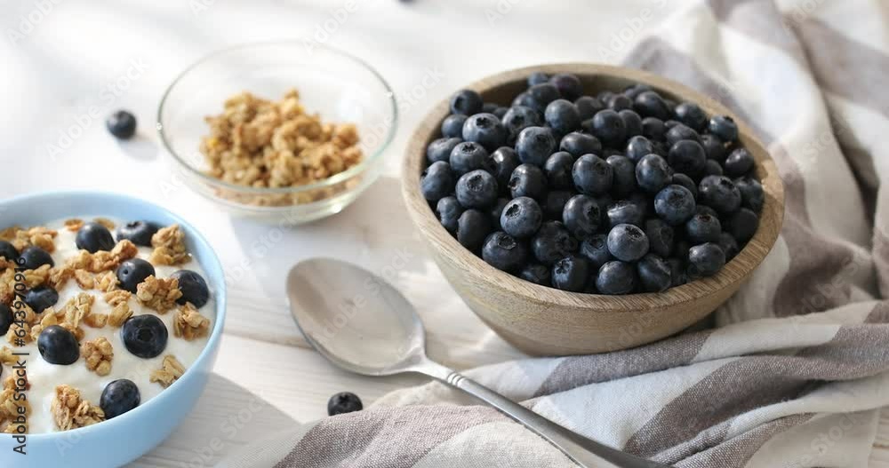 Granola with yogurt and blueberries. Cooking breakfast with muesli and berries. Healthly food. Granola with yogurt and blueberries. Cooking breakfast with muesli and berries. Healthly food.