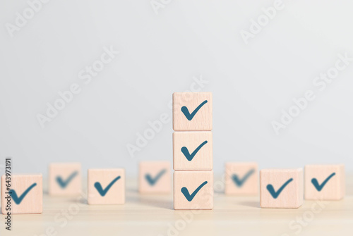 Wooden blocks display markers to summarize the details of the work. Document checklist and online quality assessment standards