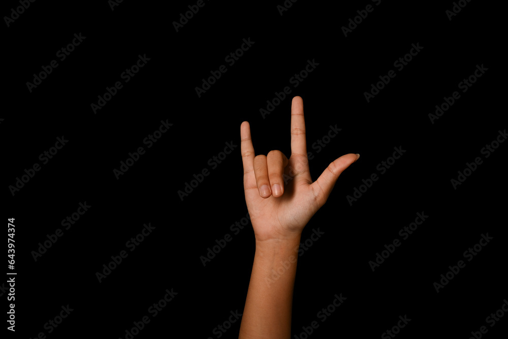 Hand showing I LOVE YOU in American sign language on black background. Love, hopeful, caring and positive vibe concept Hand showing I LOVE YOU in American sign language on black background. Love, hopeful, caring and positive vibe concept