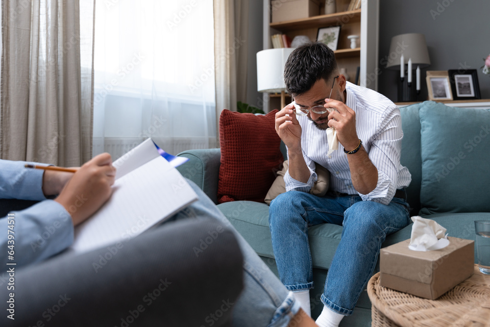 Business psychology. Female psychotherapist talks one on one with a male client who is a worker, company employee or small business owner, who is under stress and depression, without motivation