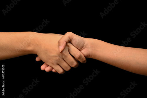 Man and woman shaking hands isolated on black background. Celebrating successful agreement, closing deal and greeting