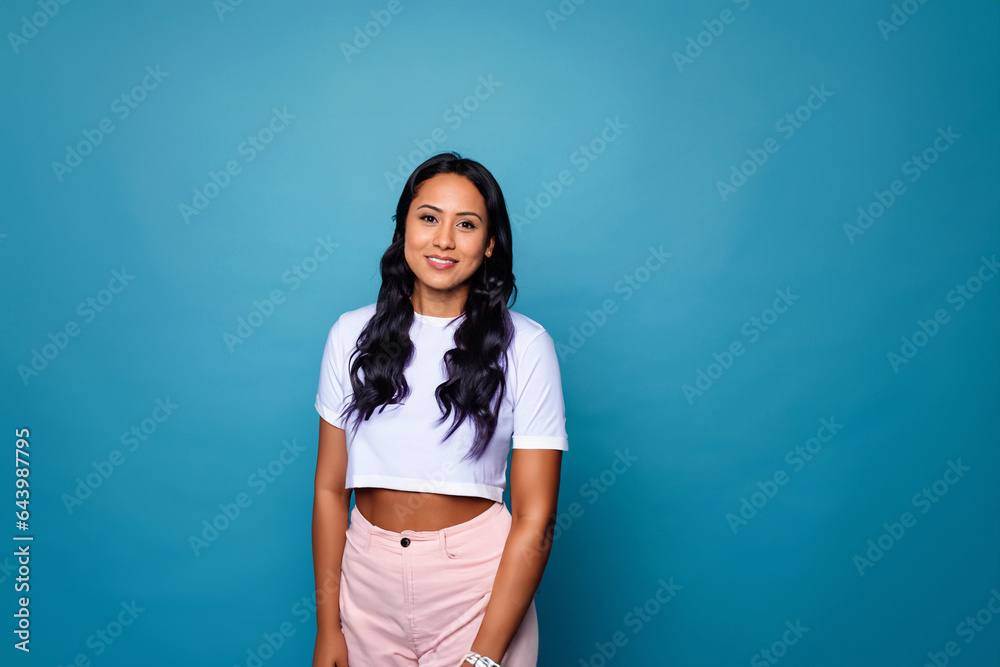 portrait of a pretty women in front of a blue background portrait of a pretty women in front of a blue background