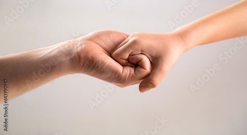 Male and child hands connected each other together and forever. Woman and kid hands connect with each other. Friendly handshake, friends greeting. Rescue, helping hand. Man help hands, protection © Yevhen
