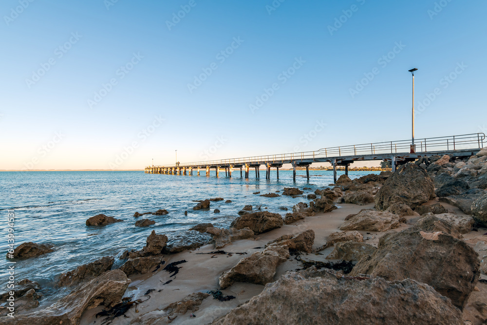 Robe jetty with fishermen while viewed towards the ocean from the shore, Limestone Coast, South Australia