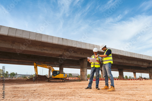 The chief civil engineer is introducing inspection of a road or expressway construction project under the road to an intern. At the expressway construction site