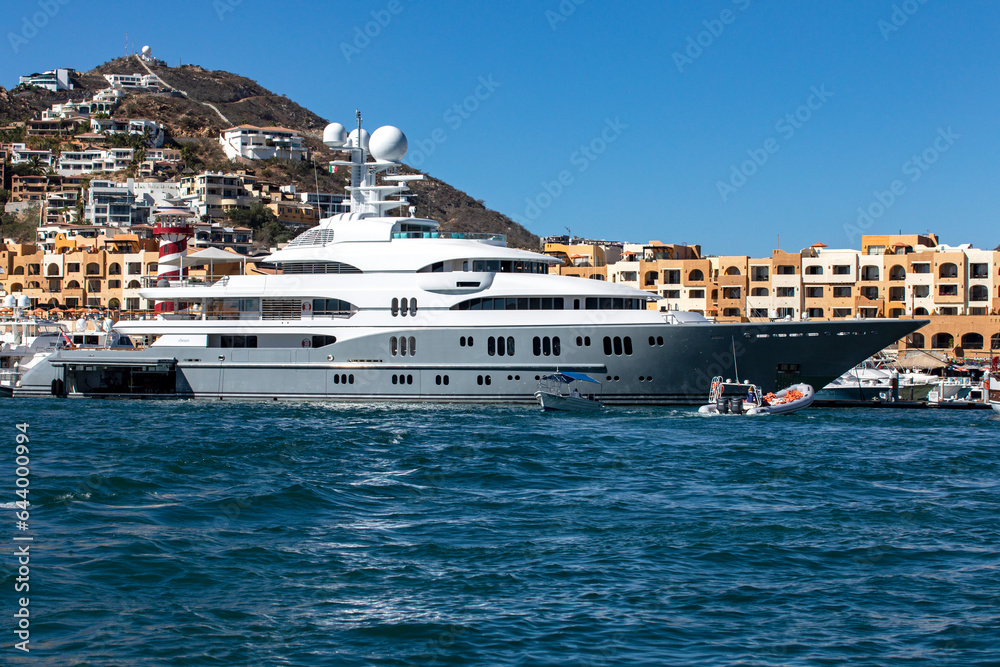 Majestic luxury yacht docked at the pier of the port of Cabo San Lucas in Mexico.