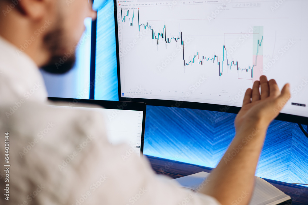Man trader working on computer on exchange market Man trader working on computer on exchange market
