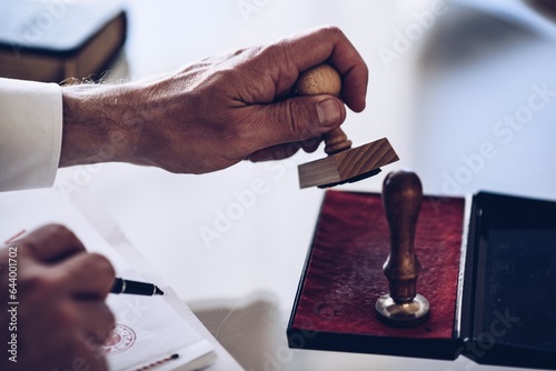 Notary or judge affixes a seal on an important official document in his office