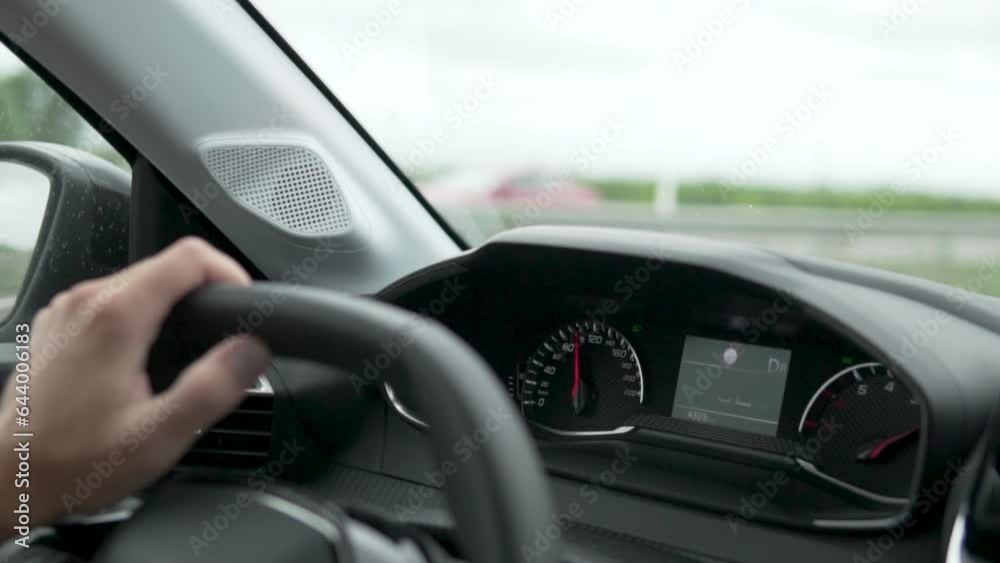 Close-up, a man driving a car with an on-board computer Close-up, a man driving a car with an on-board computer