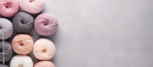 Gray and beige yarn balls used for knitting isolated pastel background Copy space