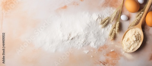 Baking preparations with eggs and a wooden spoon on a flour background making homemade food by kneading dough isolated pastel background Copy space