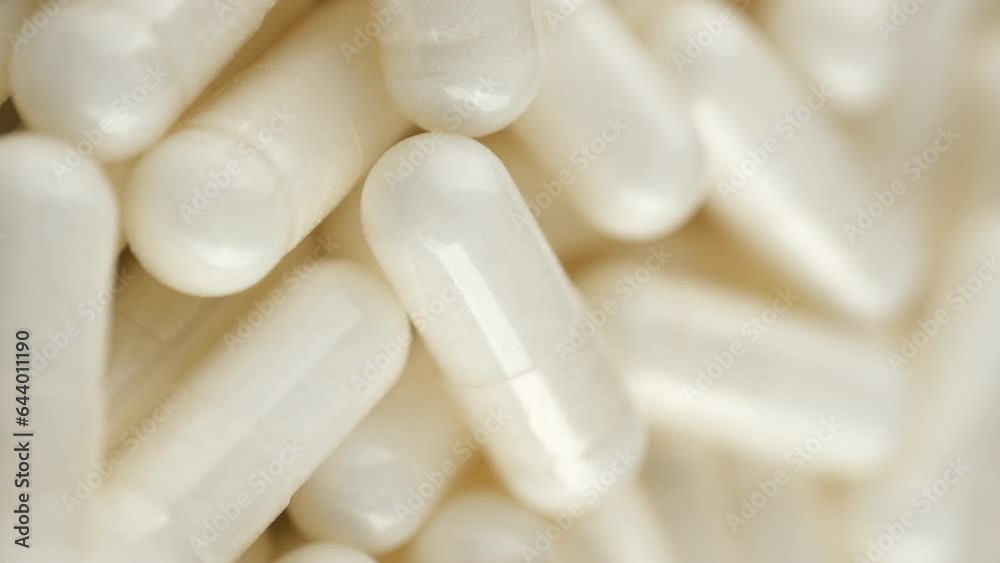 White capsule, Collagen capsule close up, rotate. Vertical video