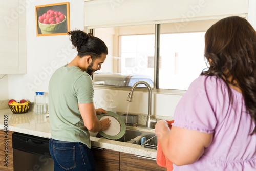 Couple doing the dishes after eating dinner together