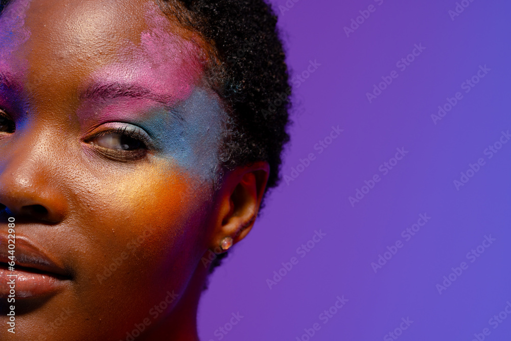 Half portrait of african american woman with short hair, colourful make up, copy space Half portrait of african american woman with short hair, colourful make up, copy space