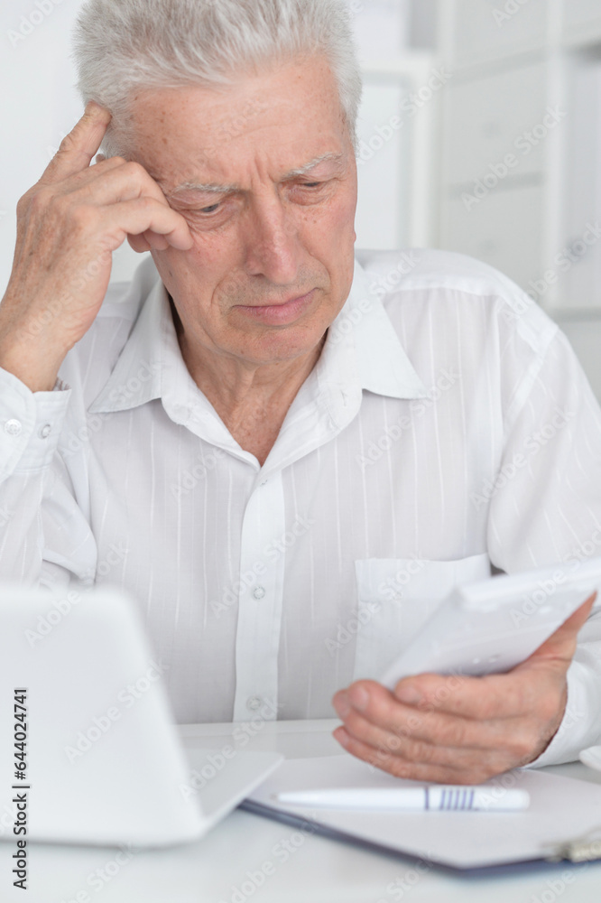 Senior businessman working with his laptop at office Senior businessman working with his laptop at office
