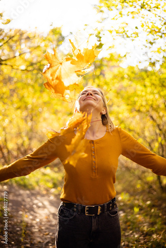 Beautiful woman in autumn park. happiness, harmony, self-care, relaxation and mindfullness