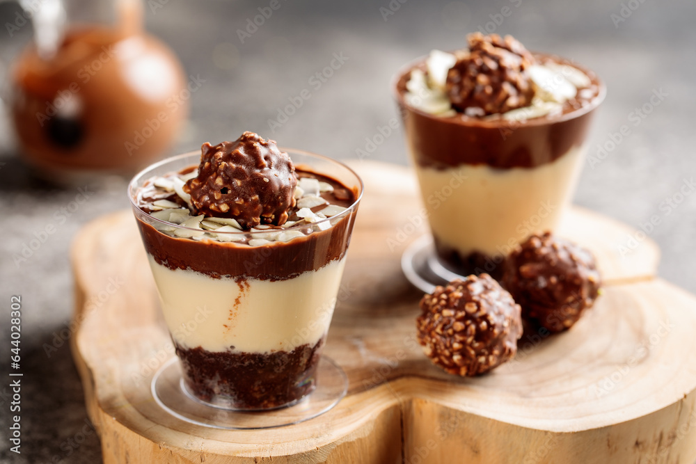 Ferrero rocher cheesecake served in cup isolated on wooden board top view cafe cheese cake food dessert Ferrero rocher cheesecake served in cup isolated on wooden board top view cafe cheese cake food dessert