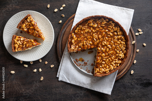 Homemade caramel-peanut cheesecake on a dark background. Morning delicious bakery cake