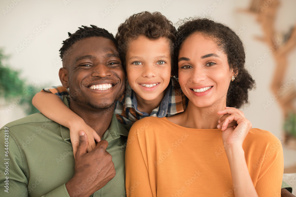 Cheerful Diverse Parents And Kid Son Hugging At Home Cheerful Diverse Parents And Kid Son Hugging At Home