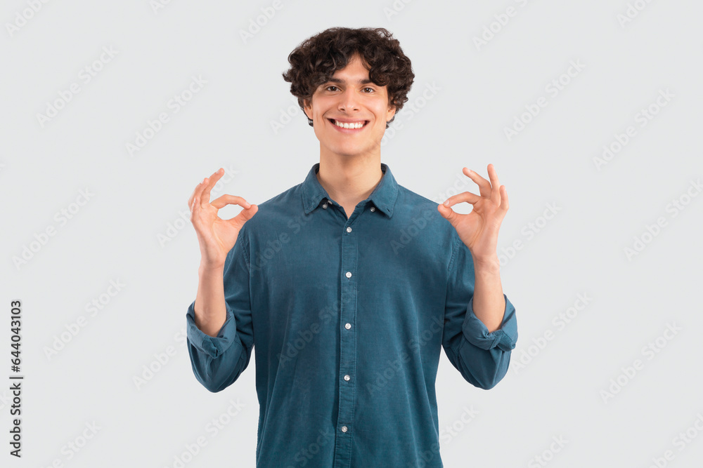 Guy in casual showing okay gesture with both hands, studio Guy in casual showing okay gesture with both hands, studio