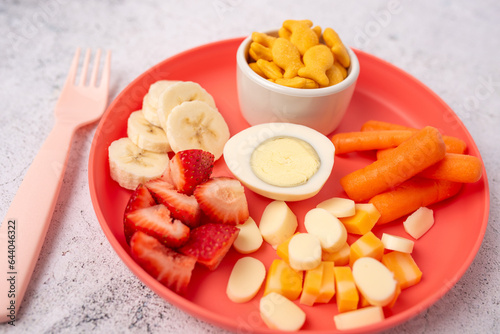 Kids lunch plate with variety of fruit, vegetable and protein. 