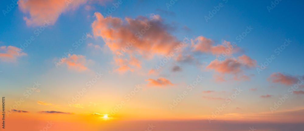 Pastel cloudscape. Sunrise sundown sky with light colorful clouds without any birds. With sun. Big size panoramic