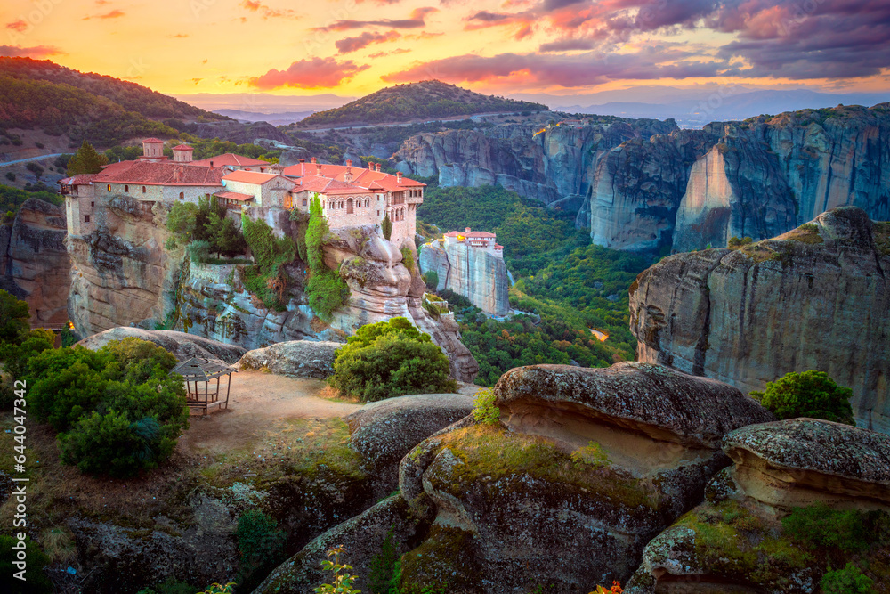 Holy Meteora. Greece, Meteora Monasteries. Panoramic view of the Holy Monastery of Varlaam, located on the edge of a high cliff. Beautiful sunrise.