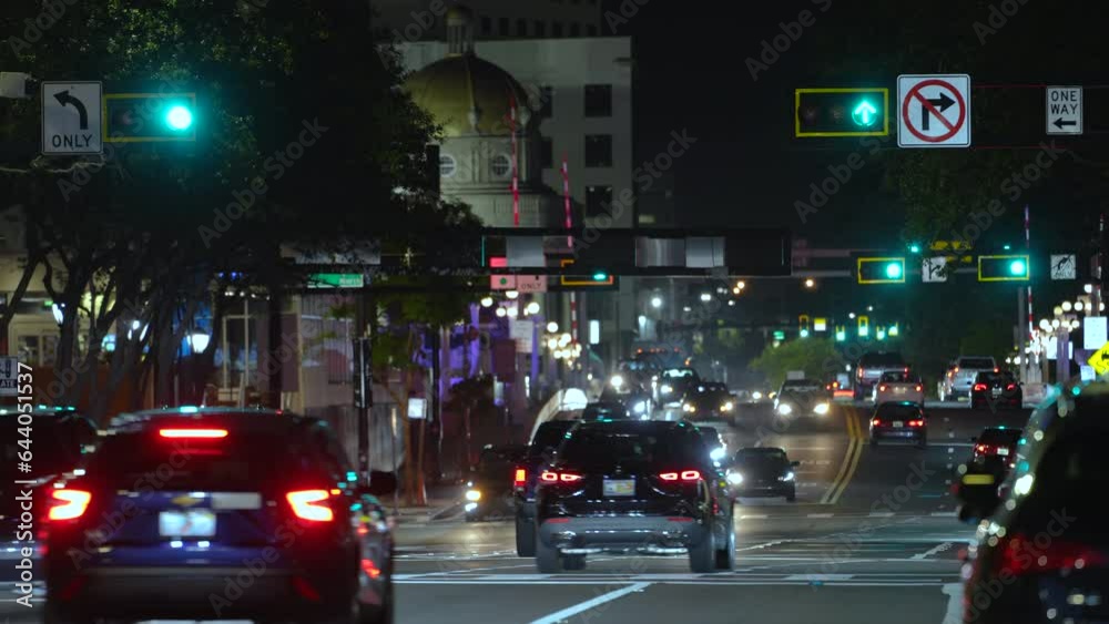 Road intersection in american city with traffic lights and moving cars at night. Transportation system in USA