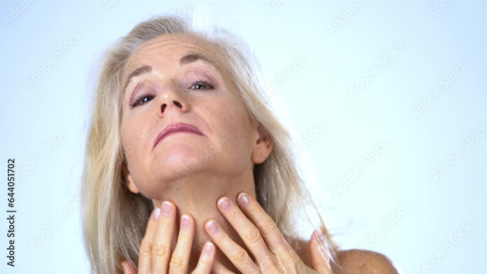 Middle aged happy mature Caucasian woman senior 50s, 60s model smiling at camera on white studio background anti-aging beauty skin care procedures face lift anti-wrinkle plastic surgery Middle aged happy mature Caucasian woman senior 50s, 60s model smiling at camera on white studio background anti-aging beauty skin care procedures face lift anti-wrinkle plastic surgery
