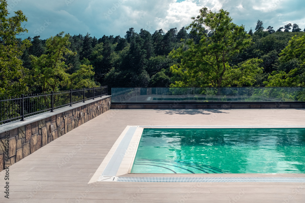Obraz premium Luxurious swimming pool in nature, calm holidays