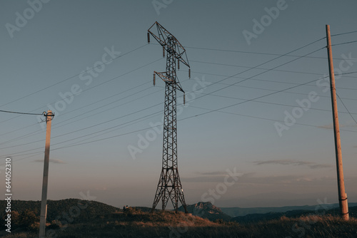 Old electricity tower, power lines in the morning