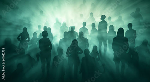 Silhouettes of people walking into light in a fog