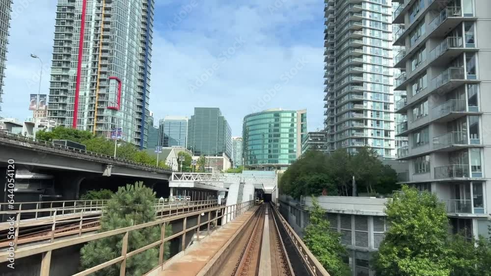 blue line skytrain front the whole process with people on the train railroad view trees summer train view big city life BC, Vancouver, Canada blue line skytrain front the whole process with people on the train railroad view trees summer train view big city life BC, Vancouver, Canada