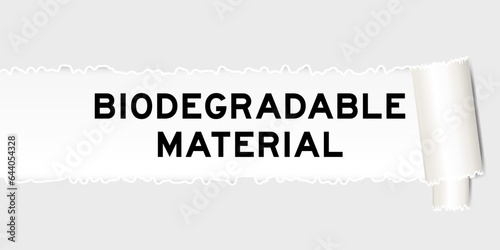 Ripped gray paper background that have word biodegradable material under torn part
