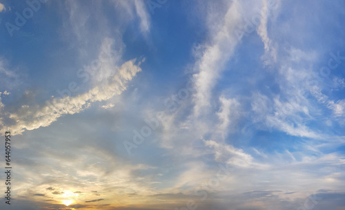 Cloudy sky. White cloud, blue sky and yellow sunlight, sunset nature background