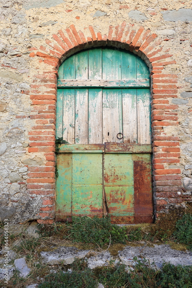 Weathered Green Wooden Stable Door in a Rural Village in Lazio, Italy Weathered Green Wooden Stable Door in a Rural Village in Lazio, Italy