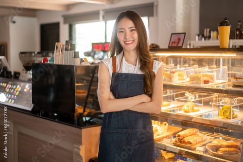 An Asian woman entrepreneur or barista working in modern coffee shop , concept small business