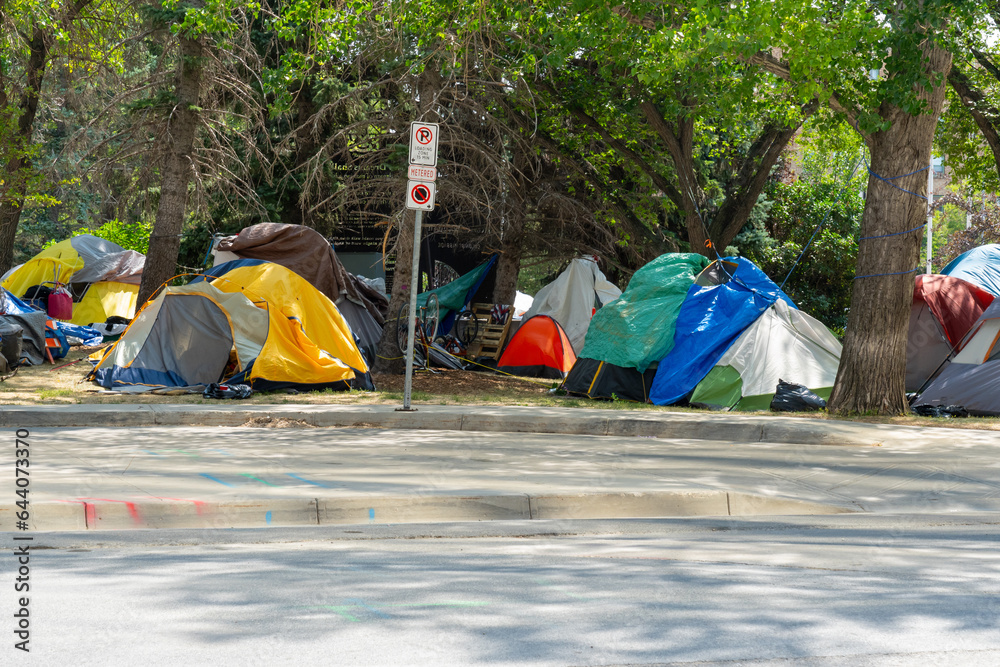 Homeless tent encampment under the trees in downtown.  Regina, Saskatchewan, Canada - July 17, 2023.  - obrazy, fototapety, plakaty 