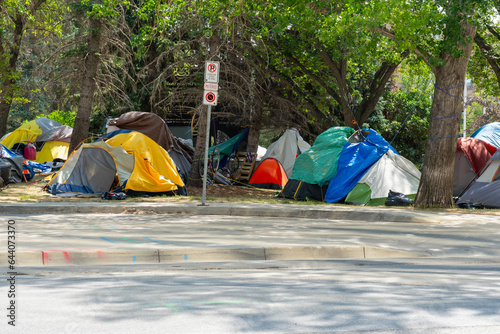 Homeless tent encampment under the trees in downtown.  Regina, Saskatchewan, Canada - July 17, 2023. 