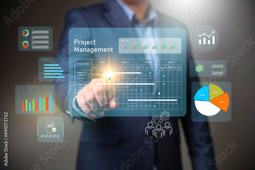 Fototapeta Naklejka Na Ścianę i Meble -  Project management concept, businessman working with schedule plan to manage work projects and update tasks. Work progress, project plan, efficient scheduling.